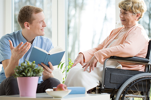 a homecare worker providing services to an older woman in a wheelchair